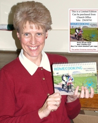 Parish secretary Lorraine McBride with the cook book.